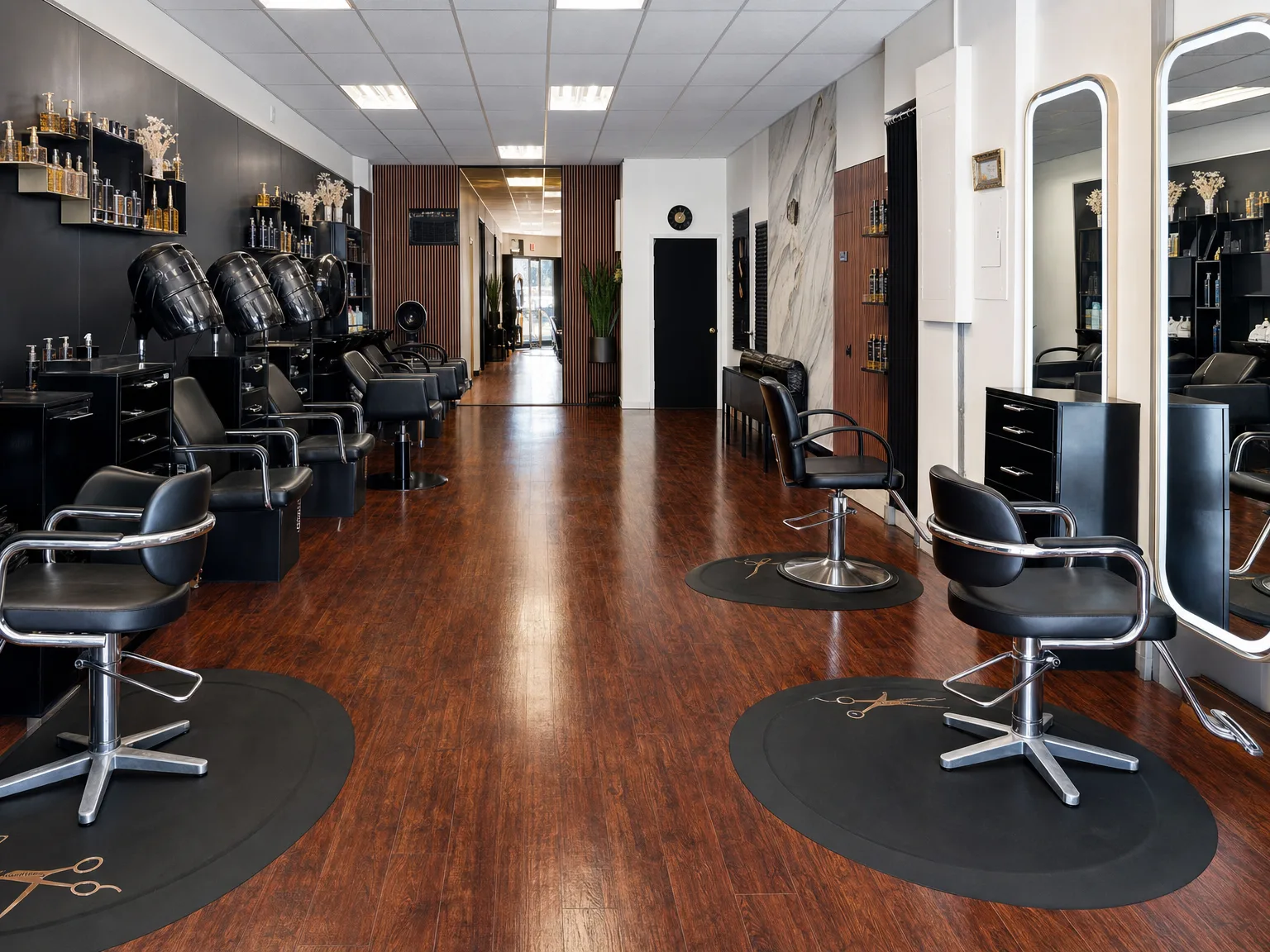 Inside Melany's Beauty Salon — the styling floor with gold-lit mirrors and black chairs